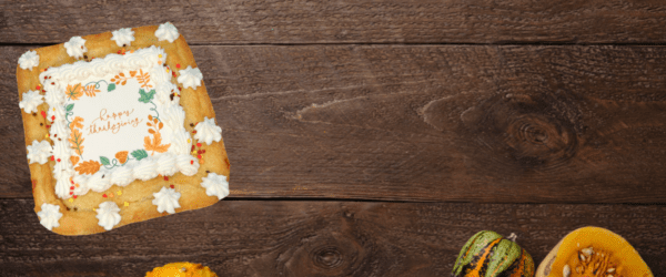 happy thanksgiving cookie on board background with gourds